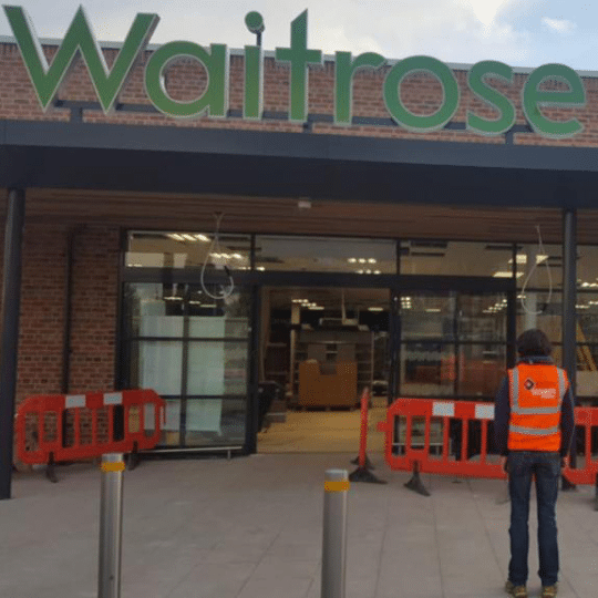 Waitrose store entrance showing signage, doors, and welcoming exterior