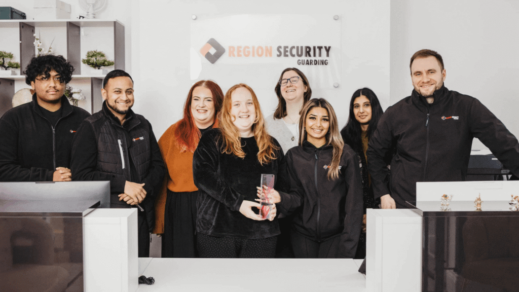 Region Security Guarding team standing together and holding their Diversity & Inclusion Award