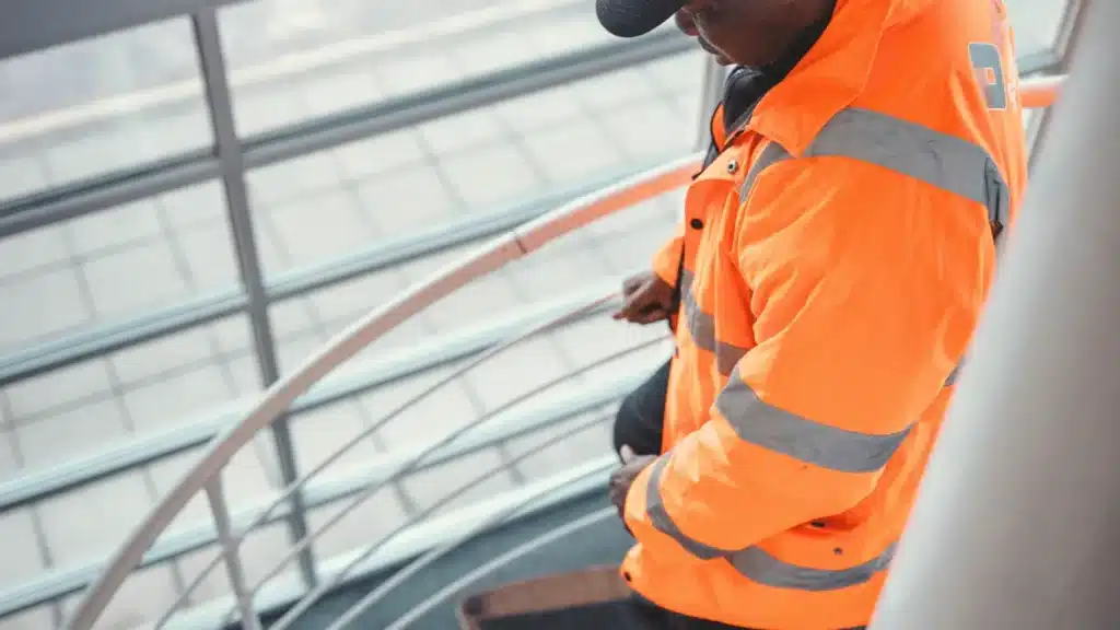 A security guard walking down curved stairs