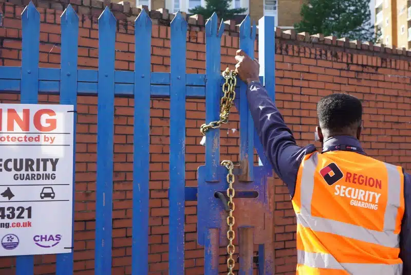 Our Beeston security guard locking up a gate on a site