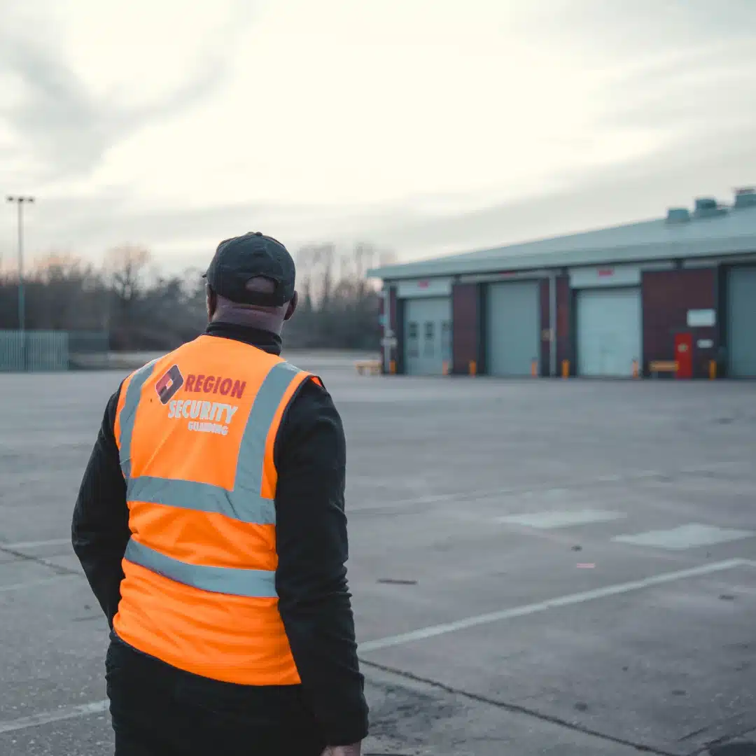 Manned guarding officer patrolling outside a Newcastle warehouse during a site security patrol