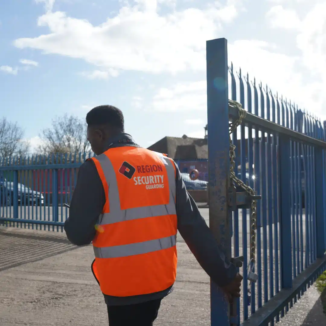 Our Daventry security guard locking a gate on site