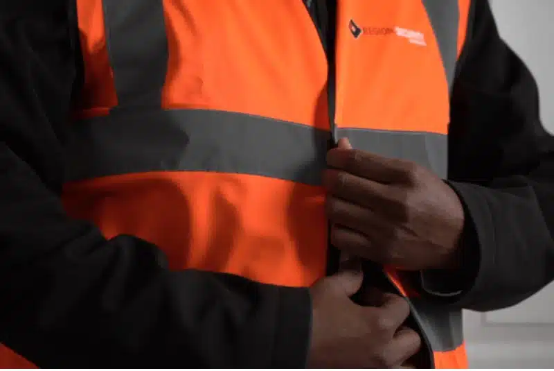 Our Mansfield retail security personnel adjusting their high-vis jacket