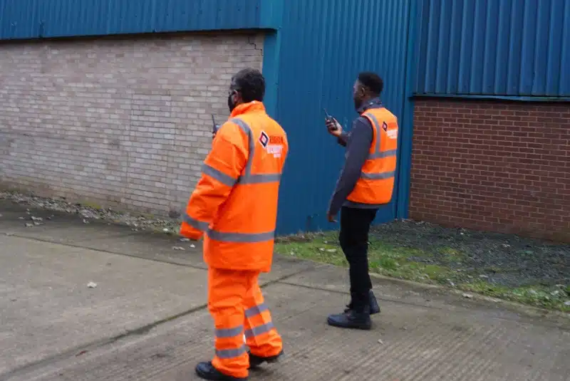 Two of our Chesterfield security guards checking the perimeter of a warehouse