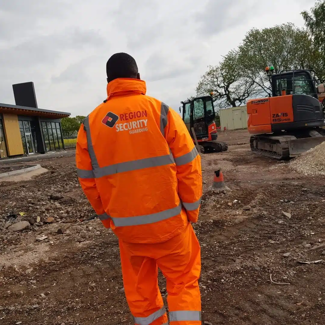 Uniformed security guard walking and monitoring a construction site in Nottingham.