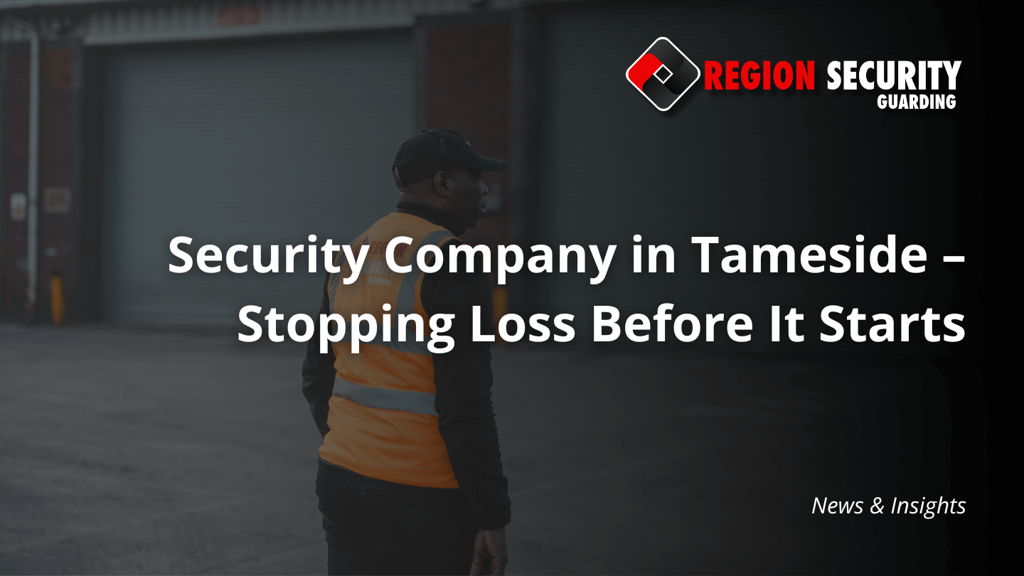 A professional from a security company in Tameside is shown on patrol, surveying a large industrial yard