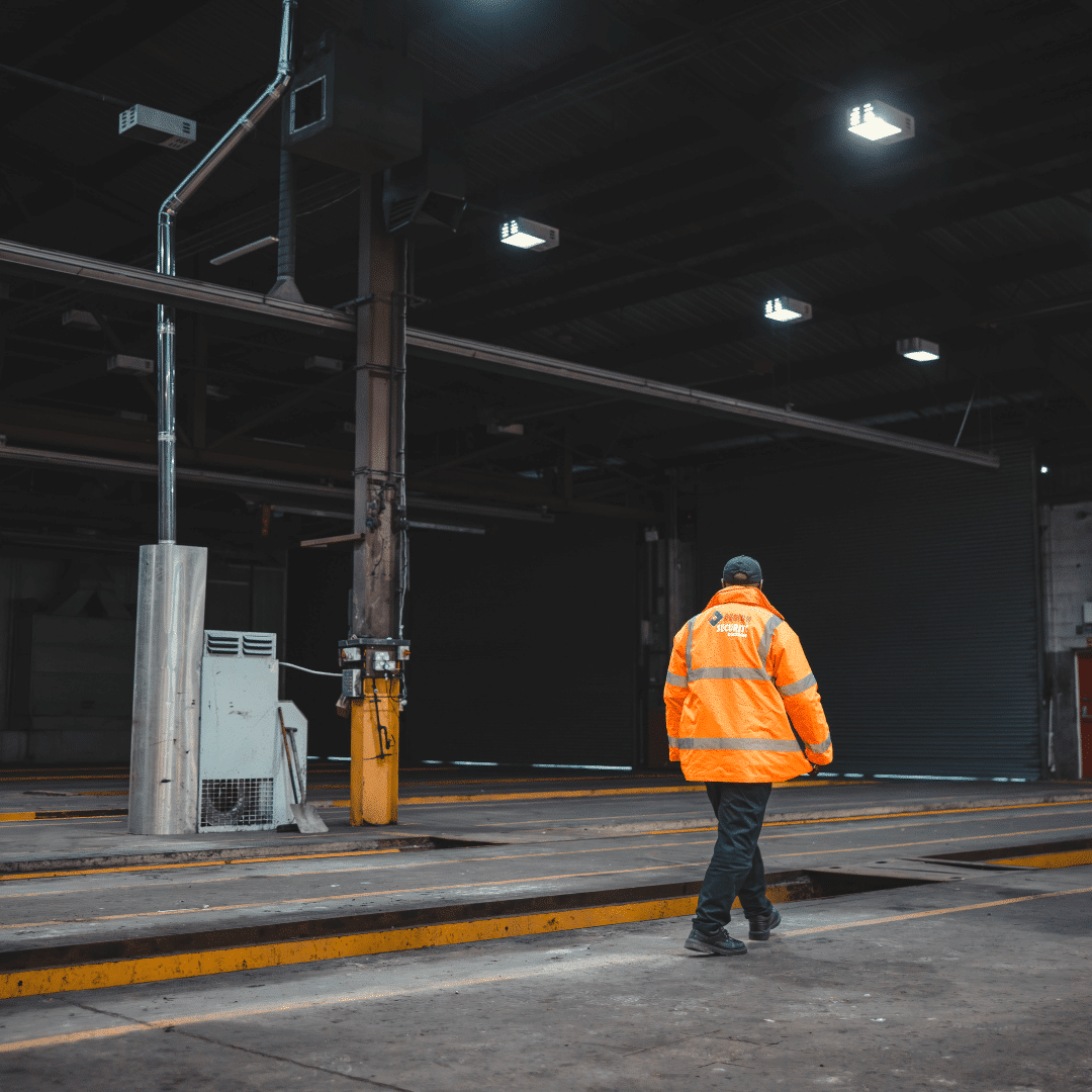 A mobile security guard from regional security guarding surveying a warehouse facility