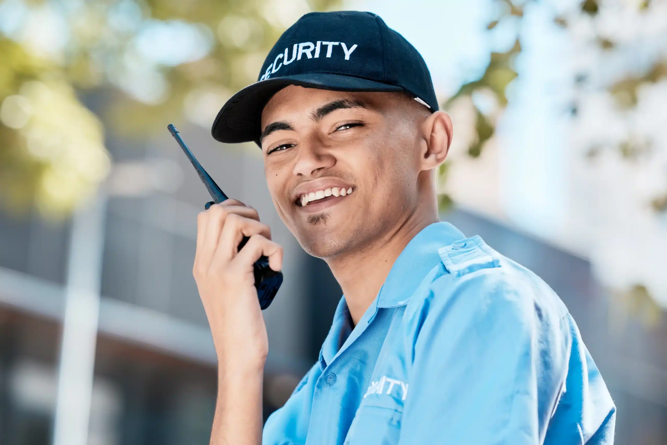 Male and female security guards communicating with a walkie-talkie during professional security operations