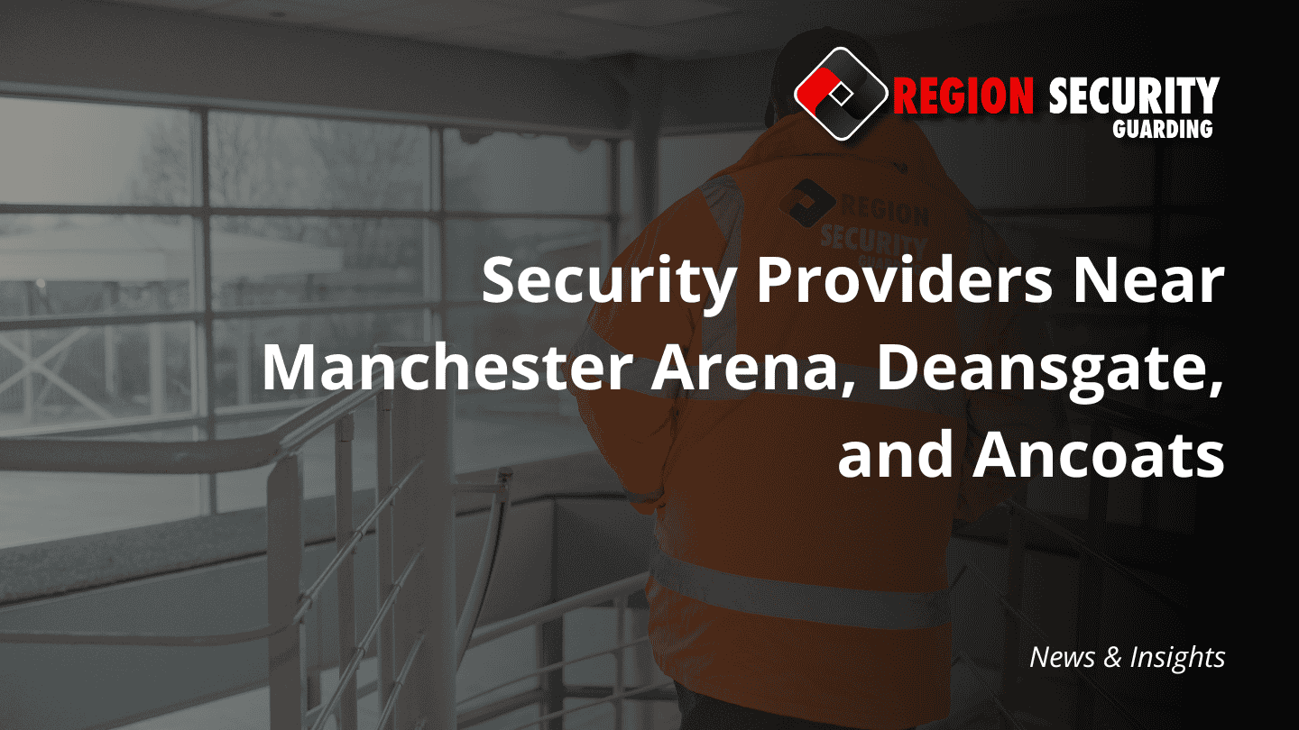 A professional security guard in a high-visibility jacket surveys a large commercial space, representing expert security providers near Manchester.