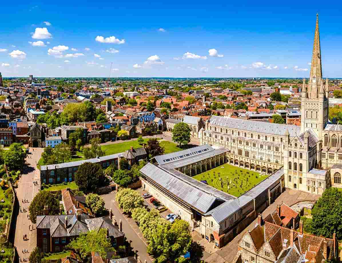 Aerial view of Norwich city centre featuring historic cathedral buildings and surrounding urban landscape.