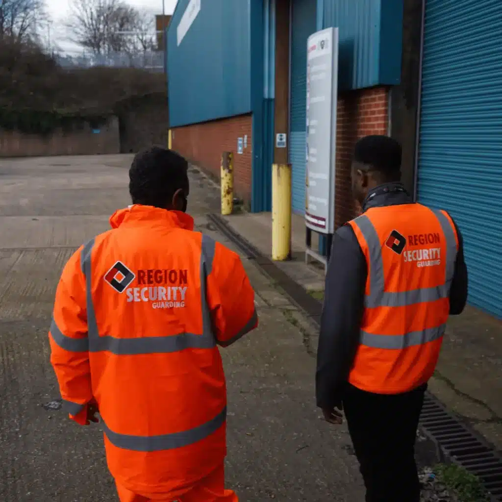 Two SIA licensed warehouse security guards patrolling a warehouse.