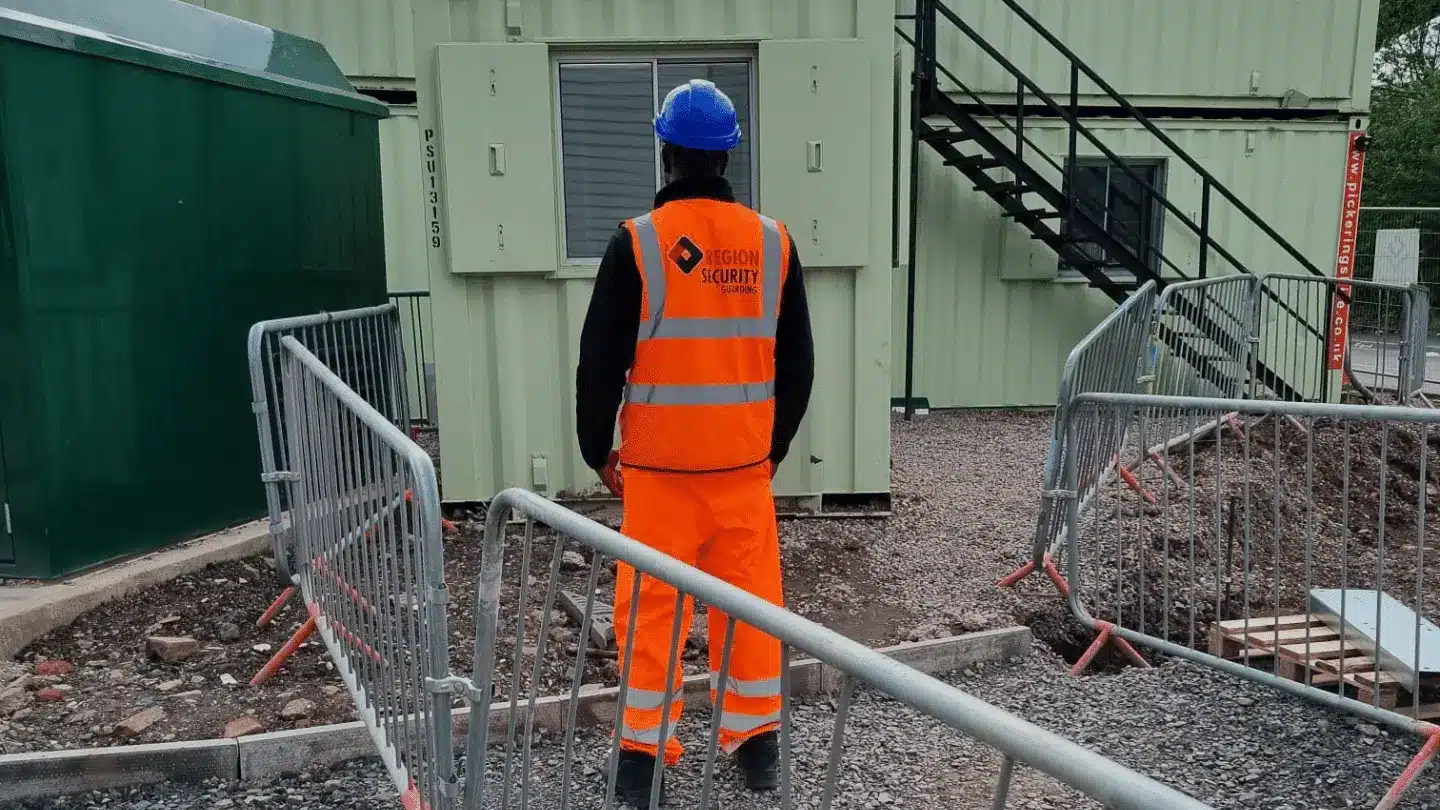 A security guard standing in the middle of a site