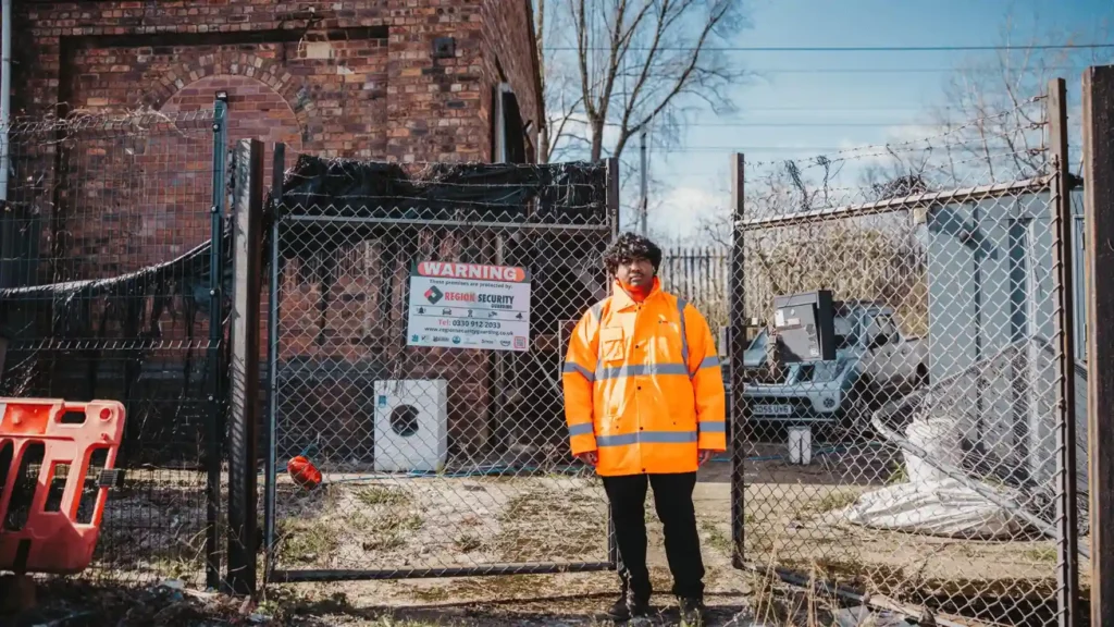 Birmingham gatehouse security officer supervising secure entry point at industrial premises