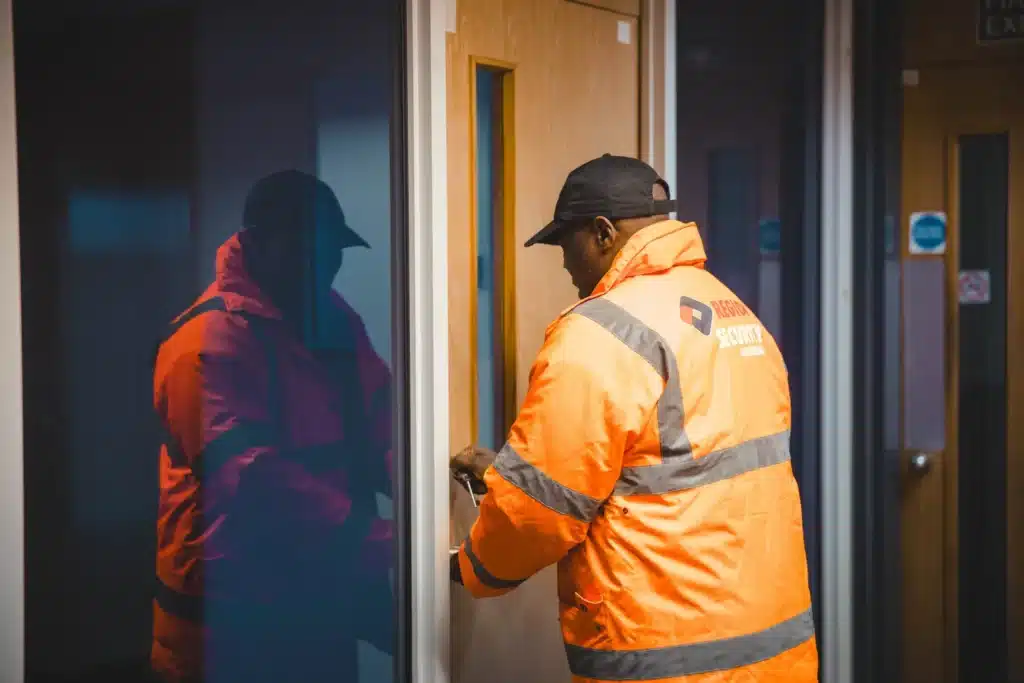 Gatehouse security guard in Birmingham locking commercial premises during routine patrol