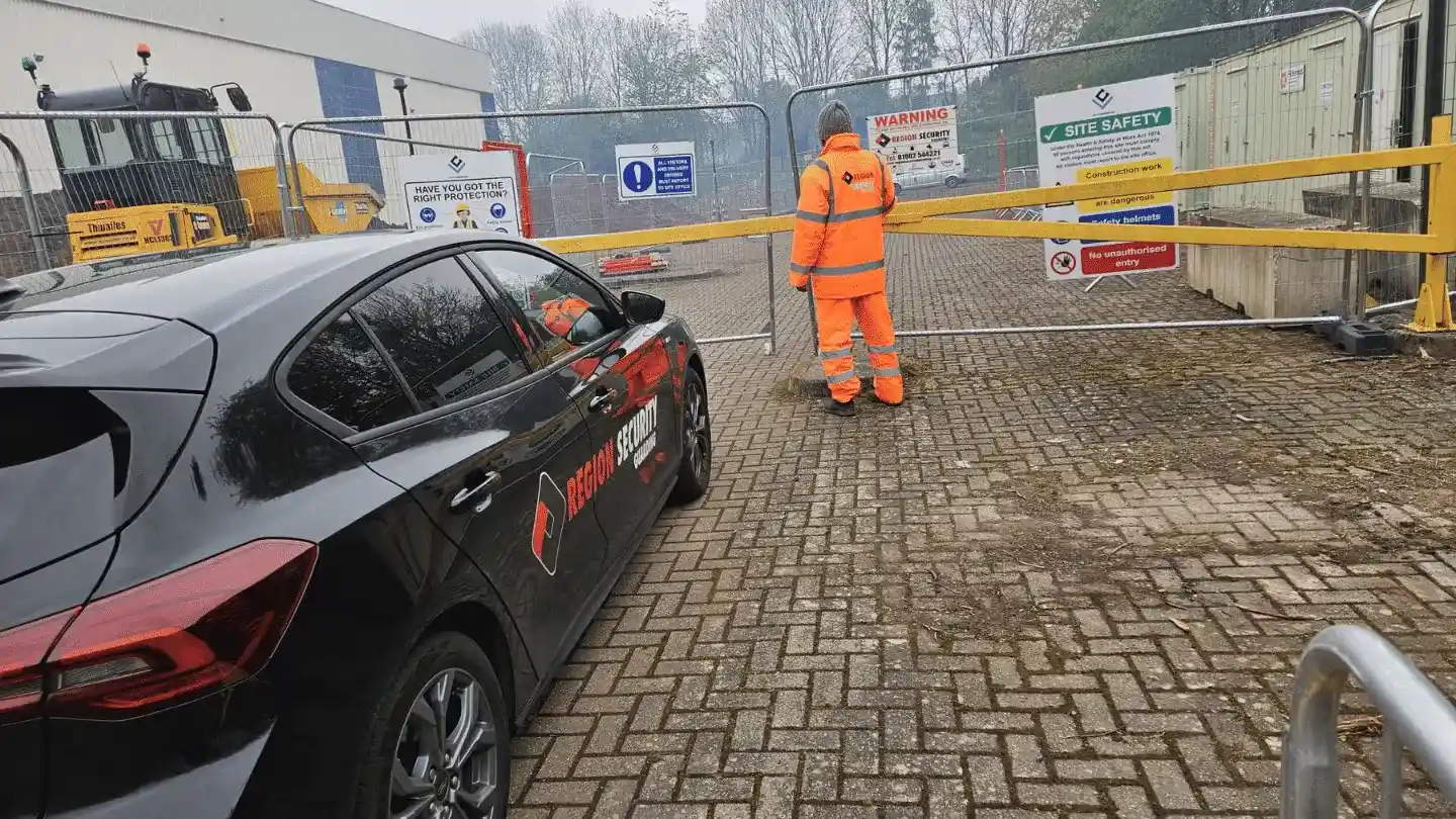 Gatehouse security guard in Birmingham controlling access at construction site entrance